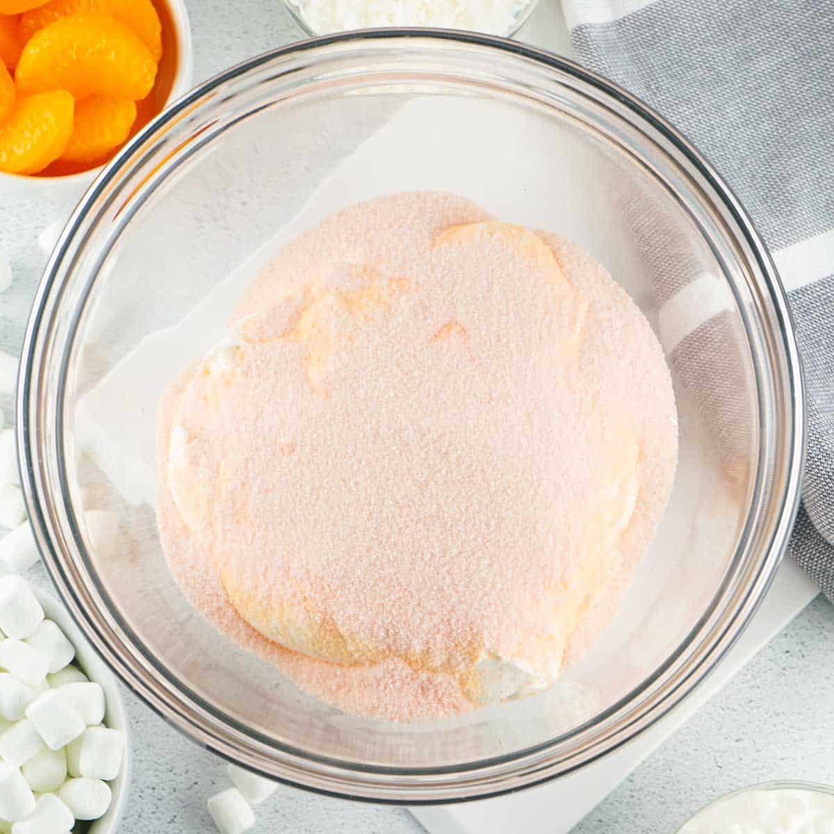 mixing orange fluff ingredients in glass bowl