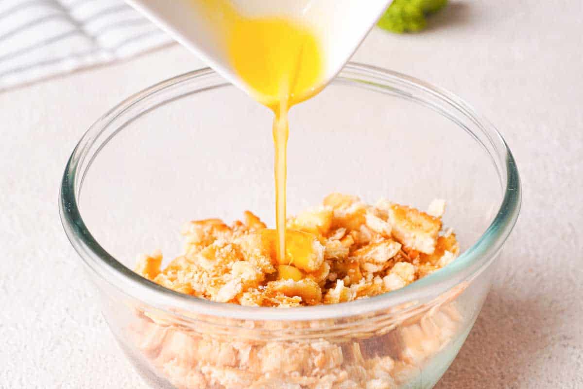 pouring butter into ritz cracker crumbs