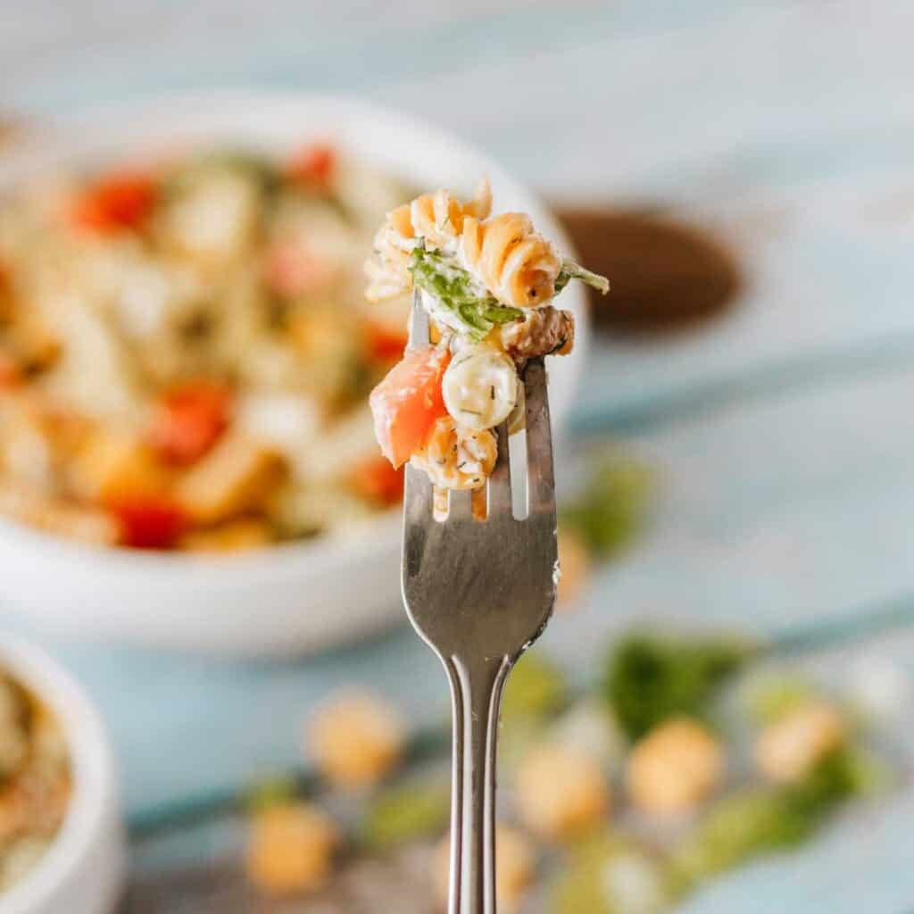 close up of fork with bite of BLT pasta salad 