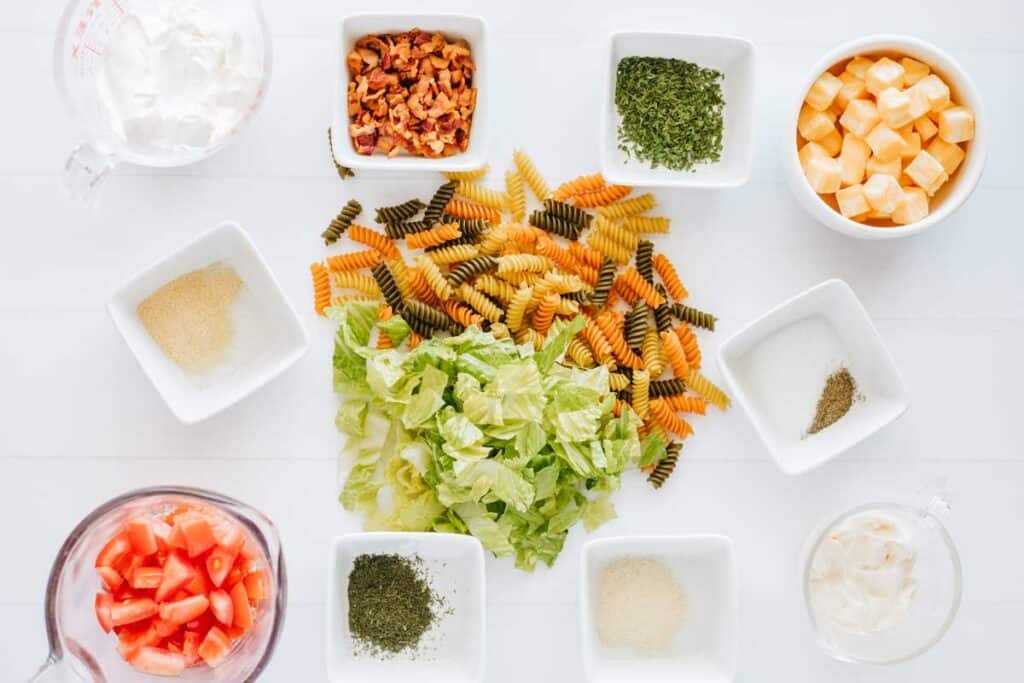 BLT pasta salad ingredients on white countertop