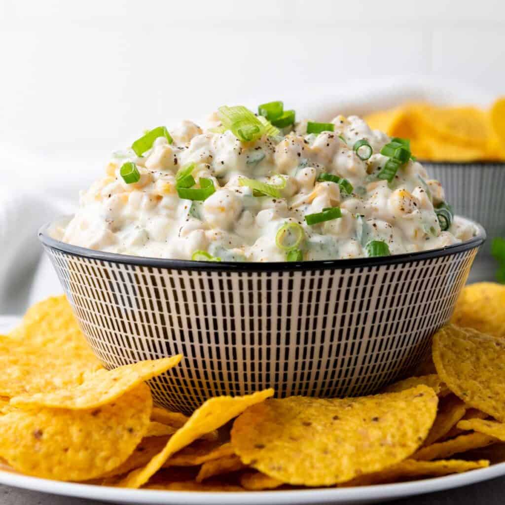 close up of bowl of crack corn dip with tortilla chips