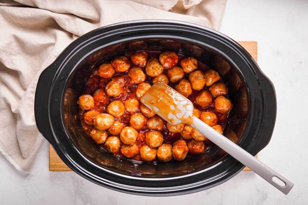 apple jelly meatballs in a slow cooker from overhead