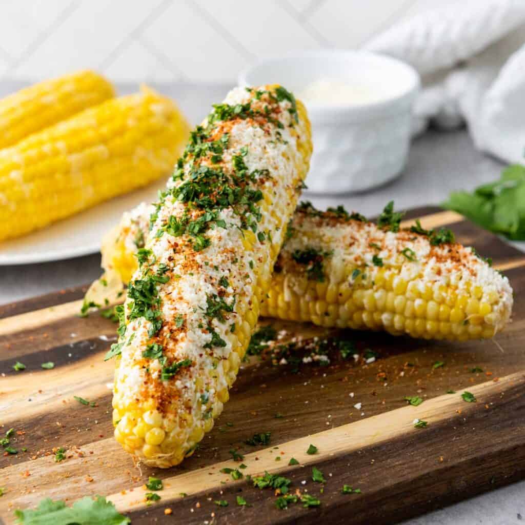 elotes Mexican street corn on wooden cutting board
