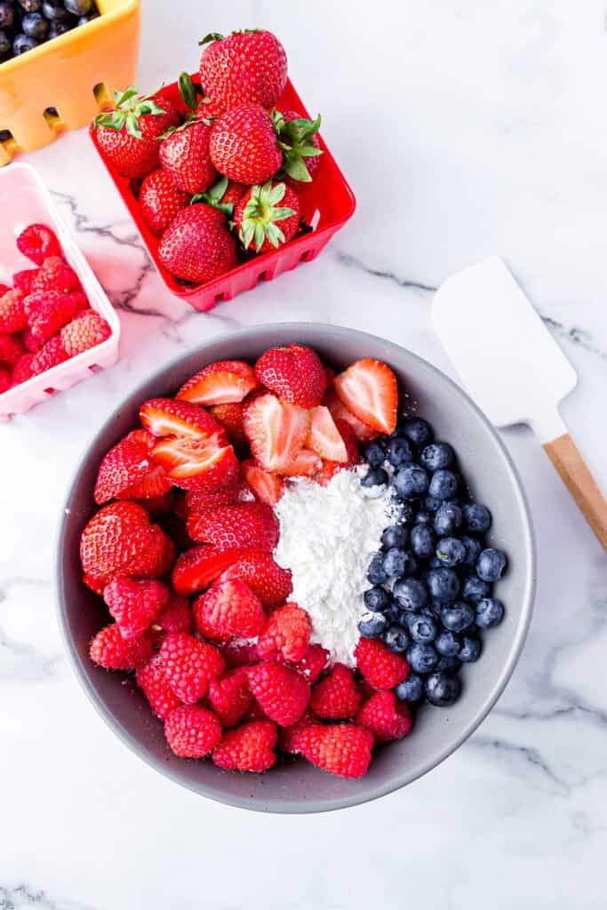 berries in bowl with cornstarch and sugar