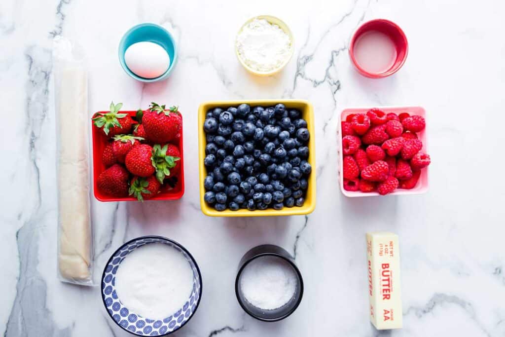 berry slab pie ingredients on marble countertop