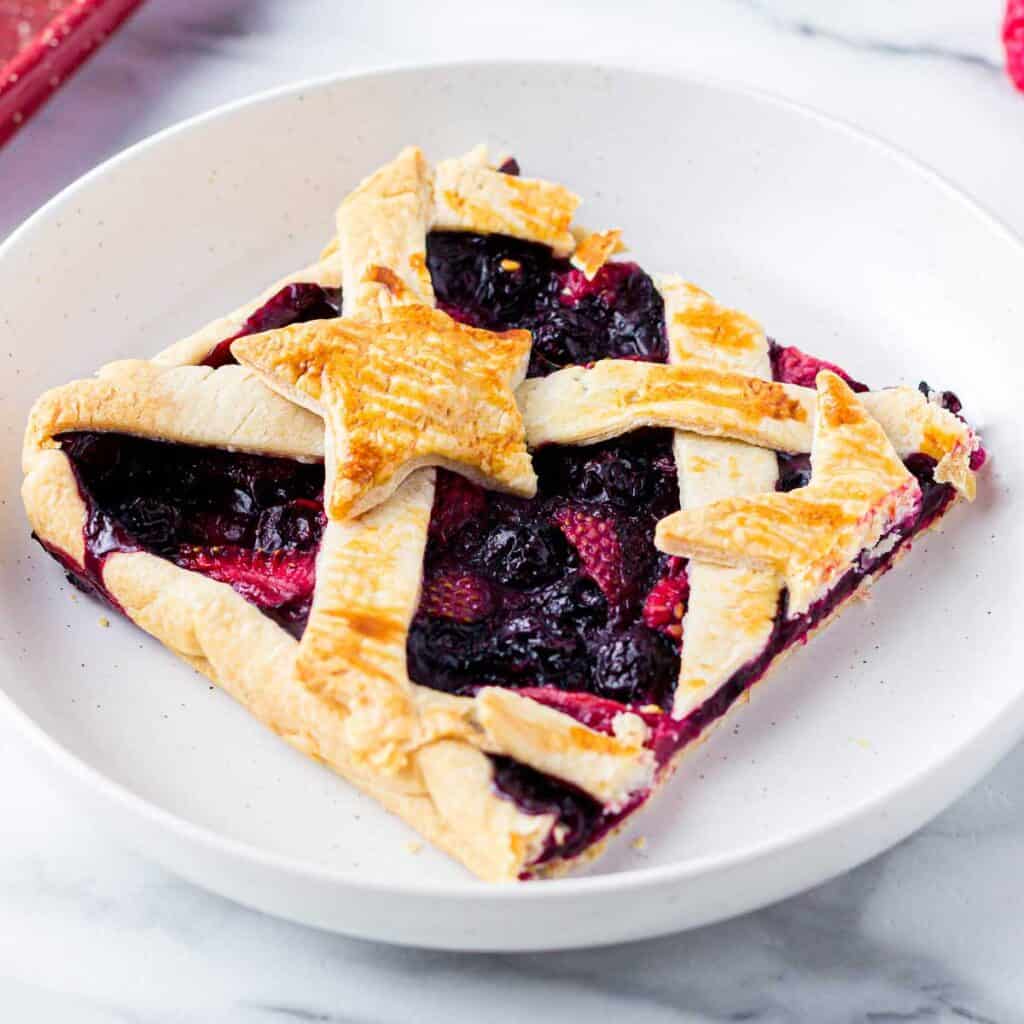 piece of patriotic berry slab pie on white plate