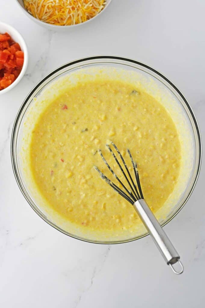 cornbread batter with corn in it in glass bowl