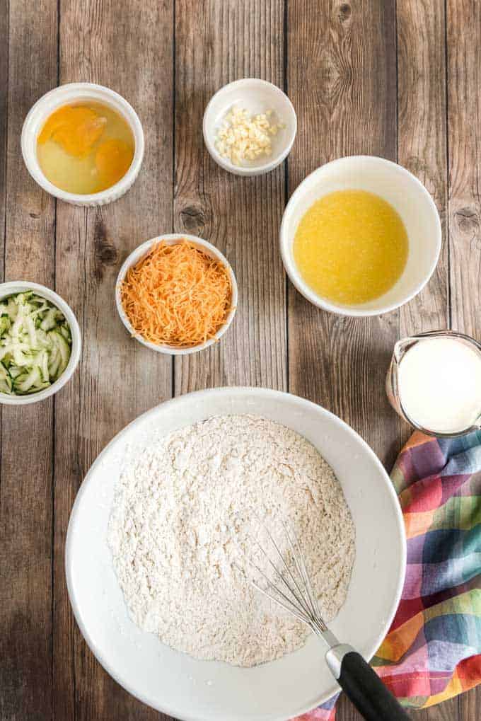 cheesy zucchini bread ingredients on wood counter