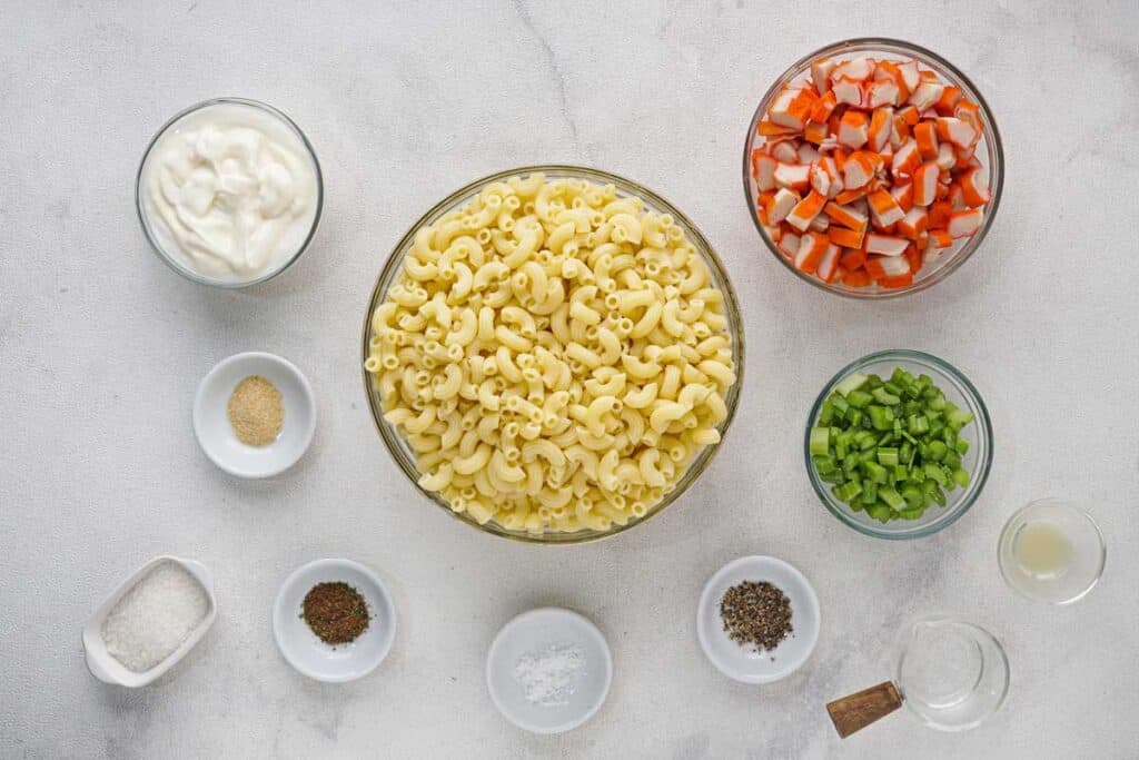 seafood pasta salad ingredients in bowls 