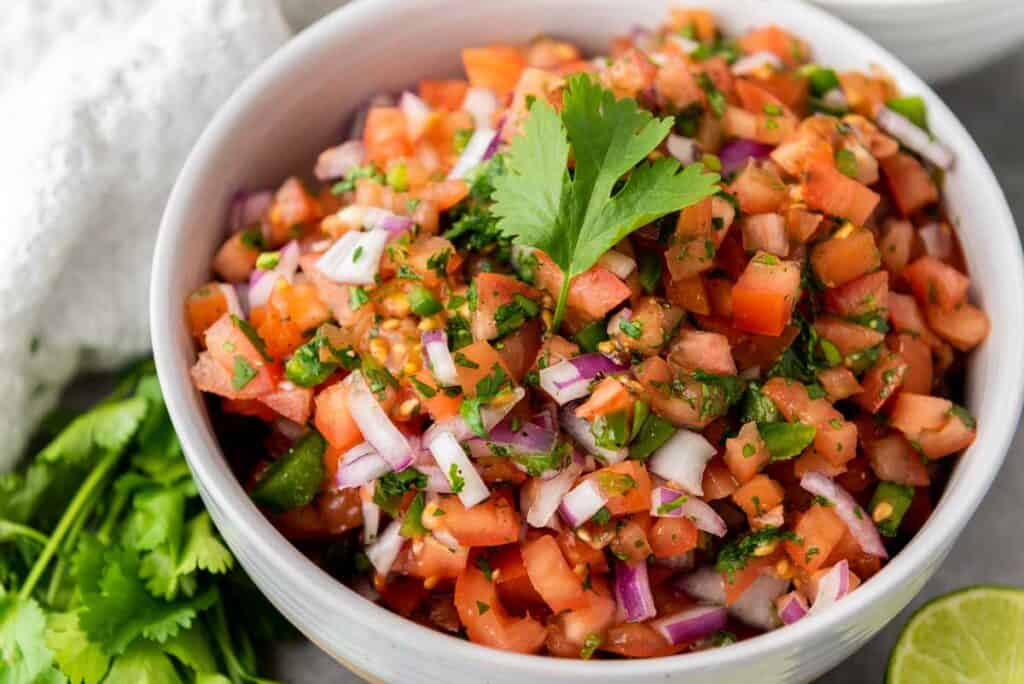 white bowl with pico de gallo garnish with cilantro