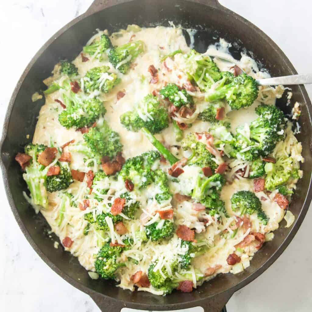 creamy bacon and broccoli in cast iron pan