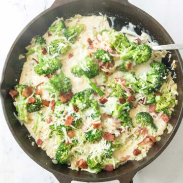 bacon and broccoli in a garlic cream sauce in pan