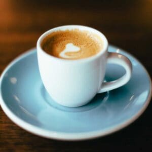 latte in light blue mug and saucer