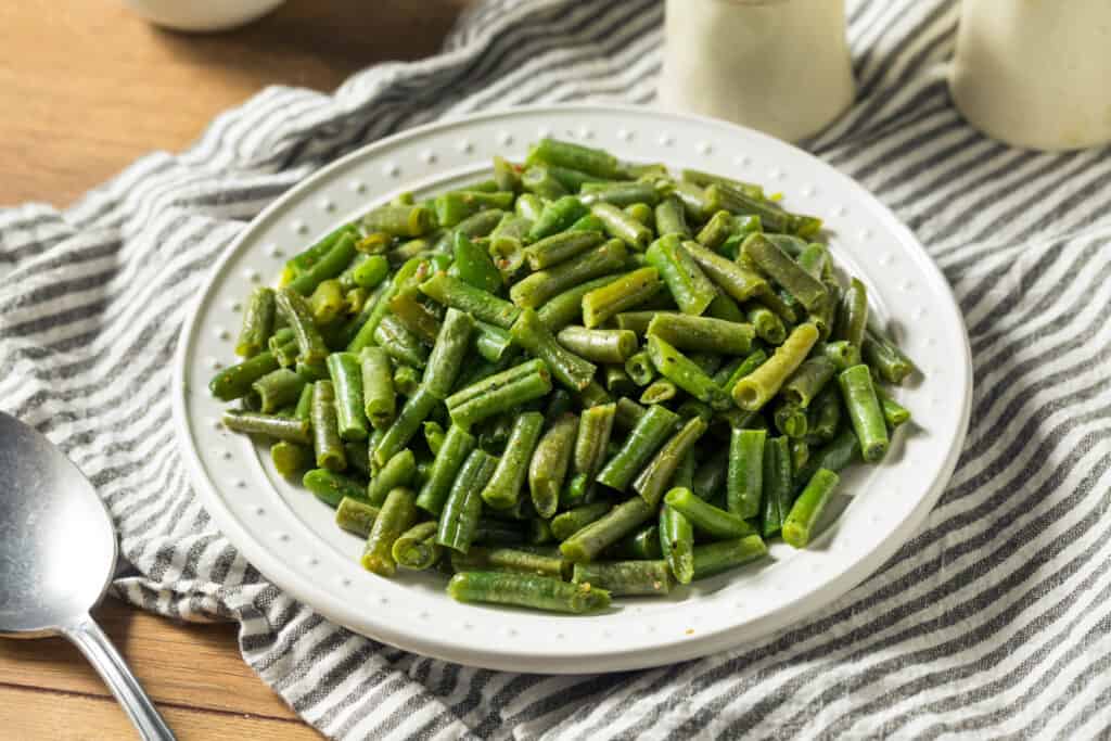 sautéed canned green beans on white plate