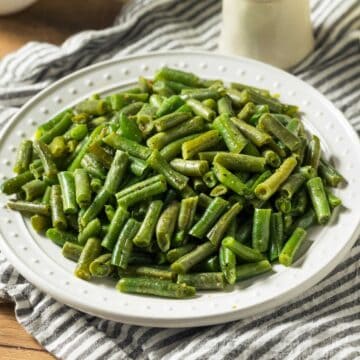 sautéed canned green beans on white plate
