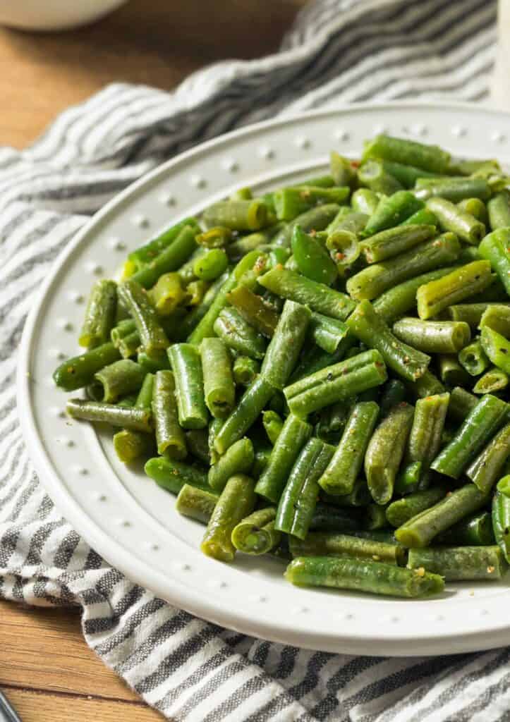 sauteed canned green beans on white plate