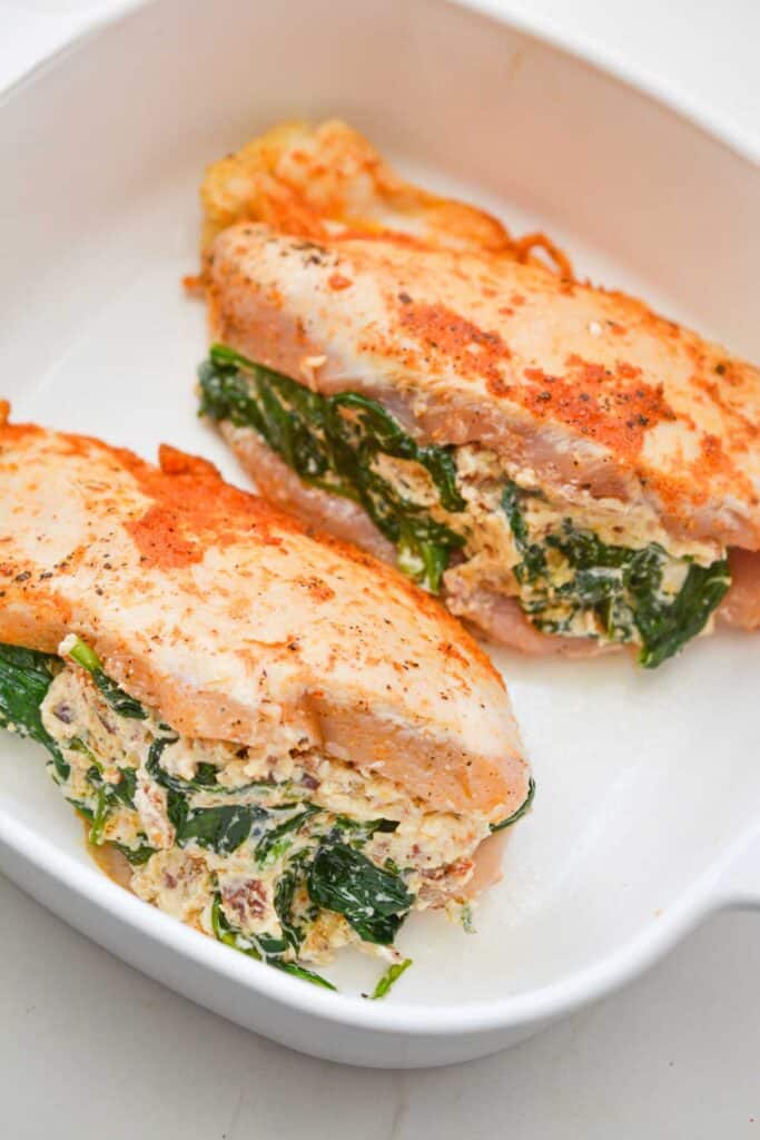 spinach stuffed chicken breast in baking dish before baking