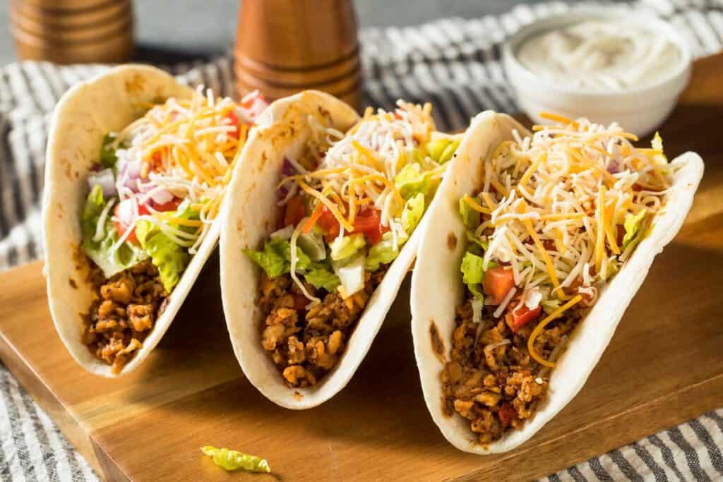 three tacos with cheese