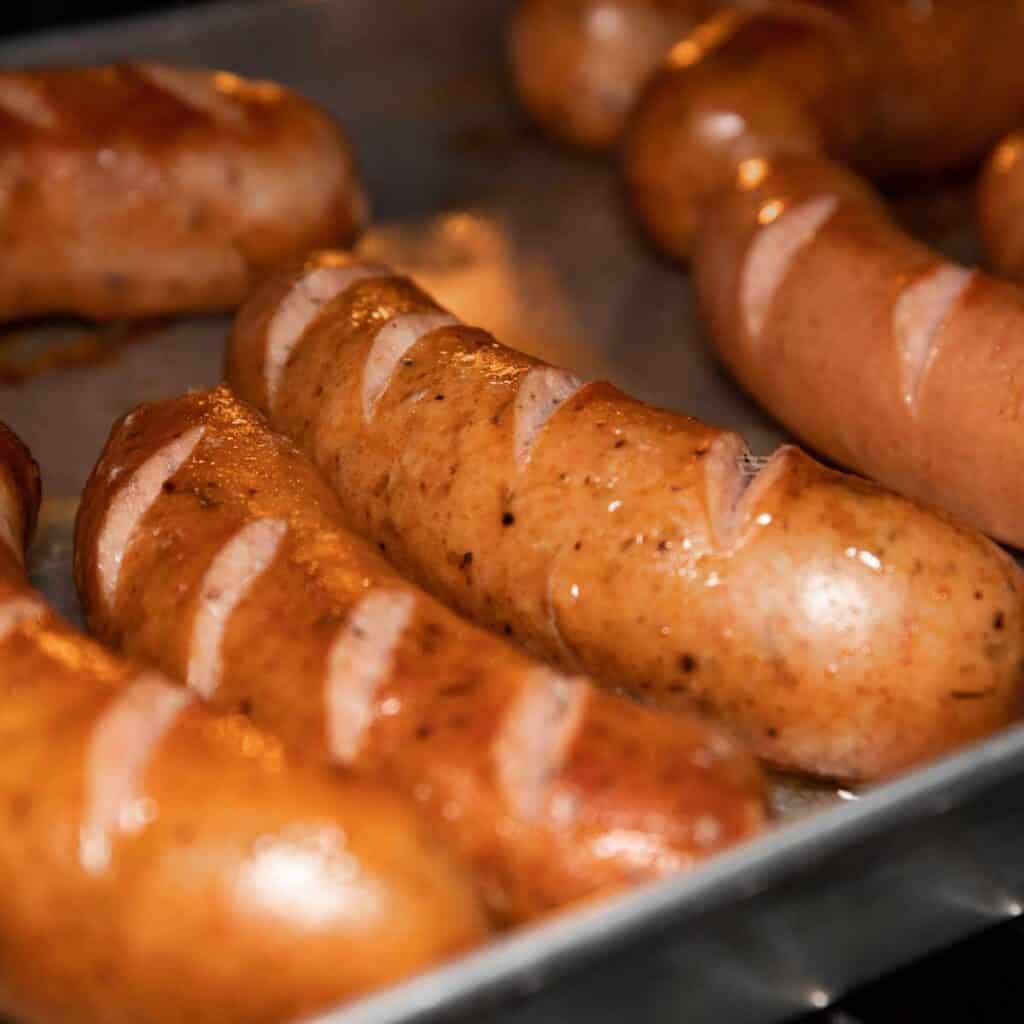 bratwursts on baking sheet