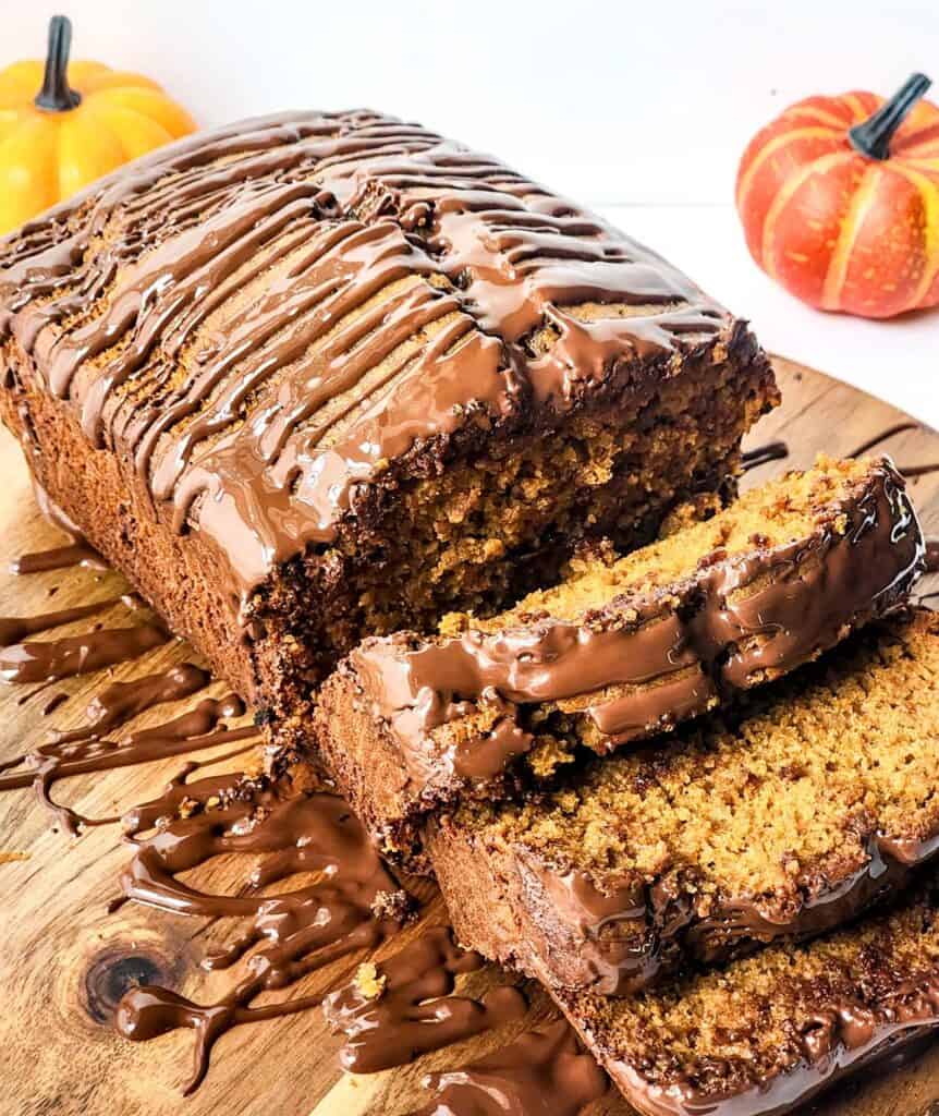 sliced pumpkin spice bread with chocolate drizzle