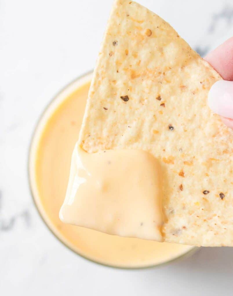 Velveeta cheese sauce on tortilla chip