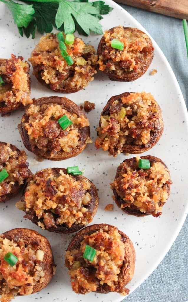 Italian stuffed mushrooms on speckled plate