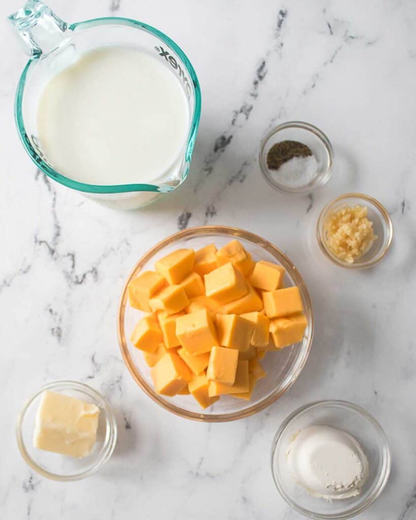 Velveeta cheese sauce ingredients on marble counter