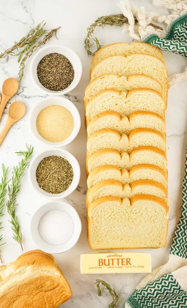 homemade sourdough croutons recipe ingredients on marble countertop