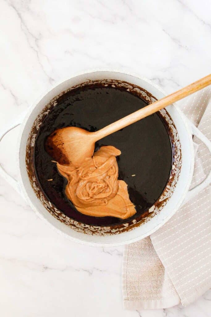 stirring peanut butter into melted butter and brown sugar