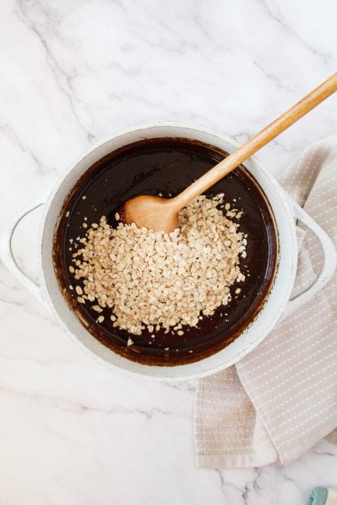 stirring oats into cookie dough mixture