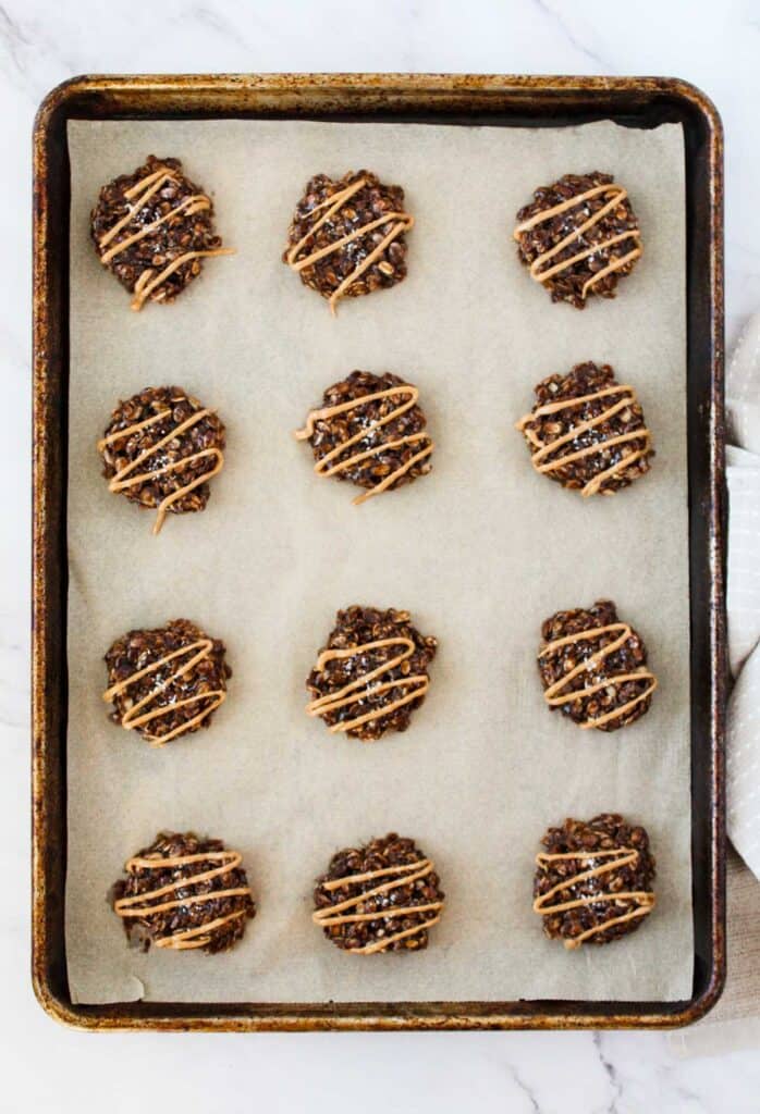 no-bake cookies with peanut butter swirl on parchment-paper-lined pan