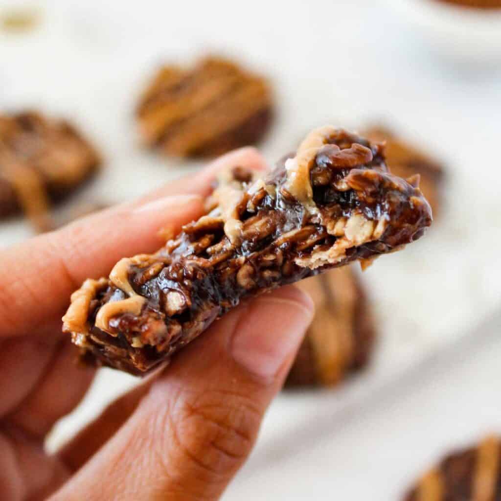 hand holding no-bake cookie with bite removed