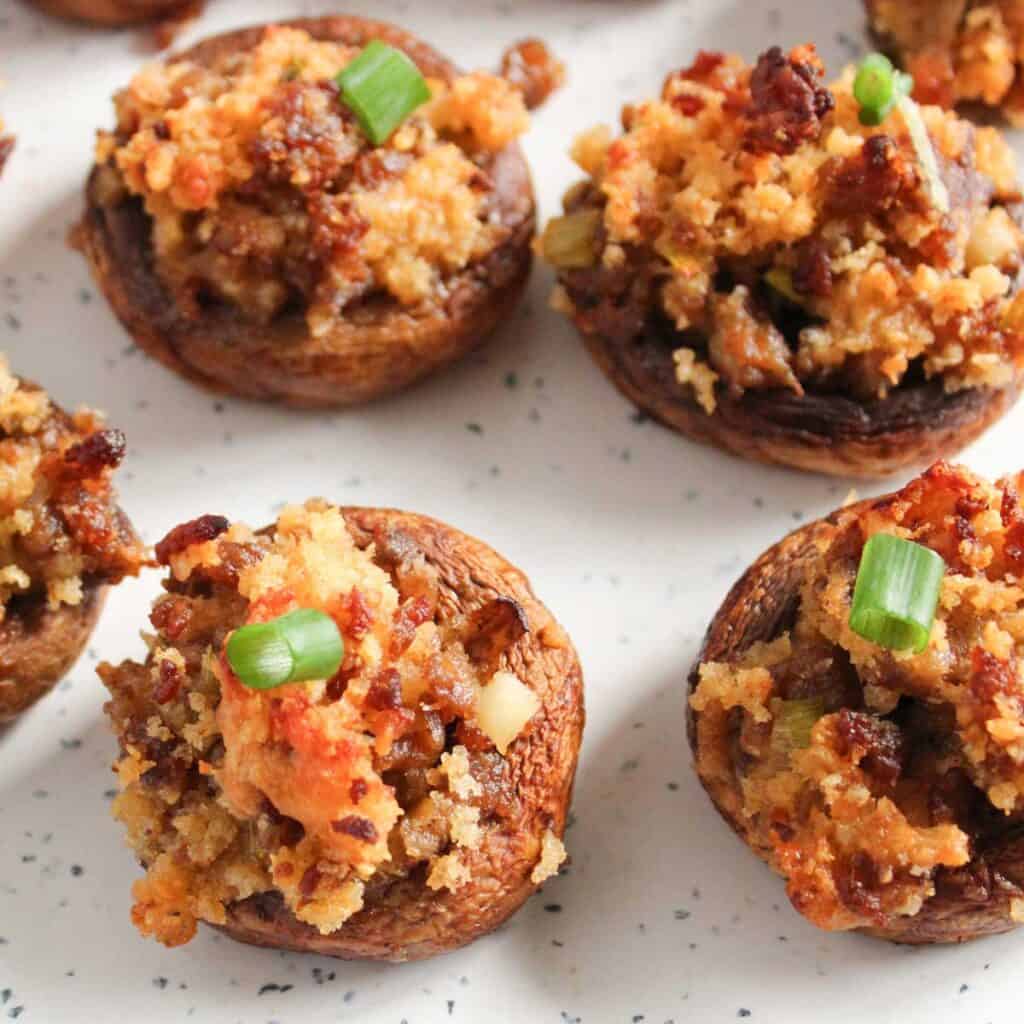 close up of Italian stuffed mushrooms with chopped green onion garnish