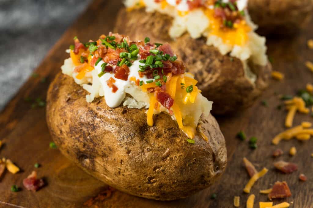baked potatoes on cutting board