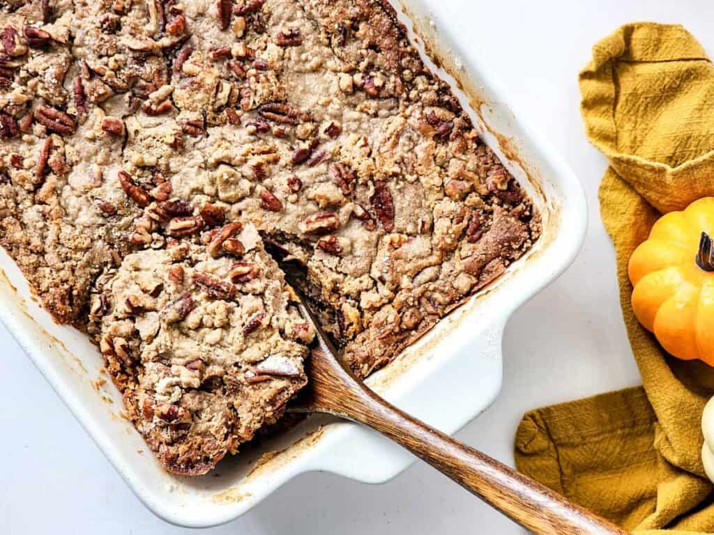 wooden spoon scooping into sweet potato dump cake