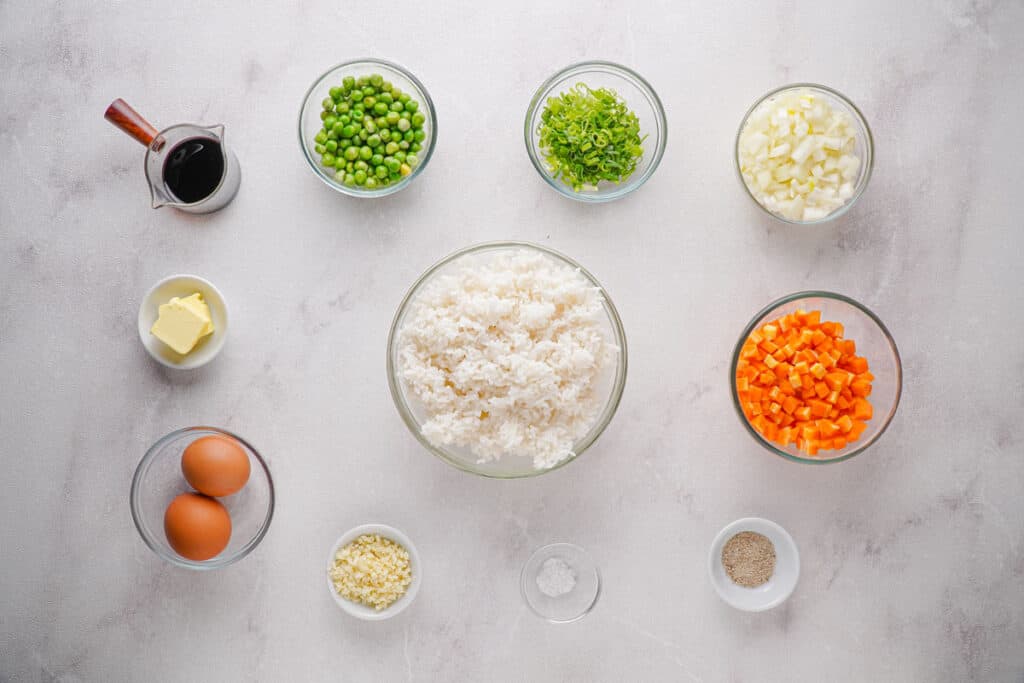 fried rice ingredients in bowls on marble countertop
