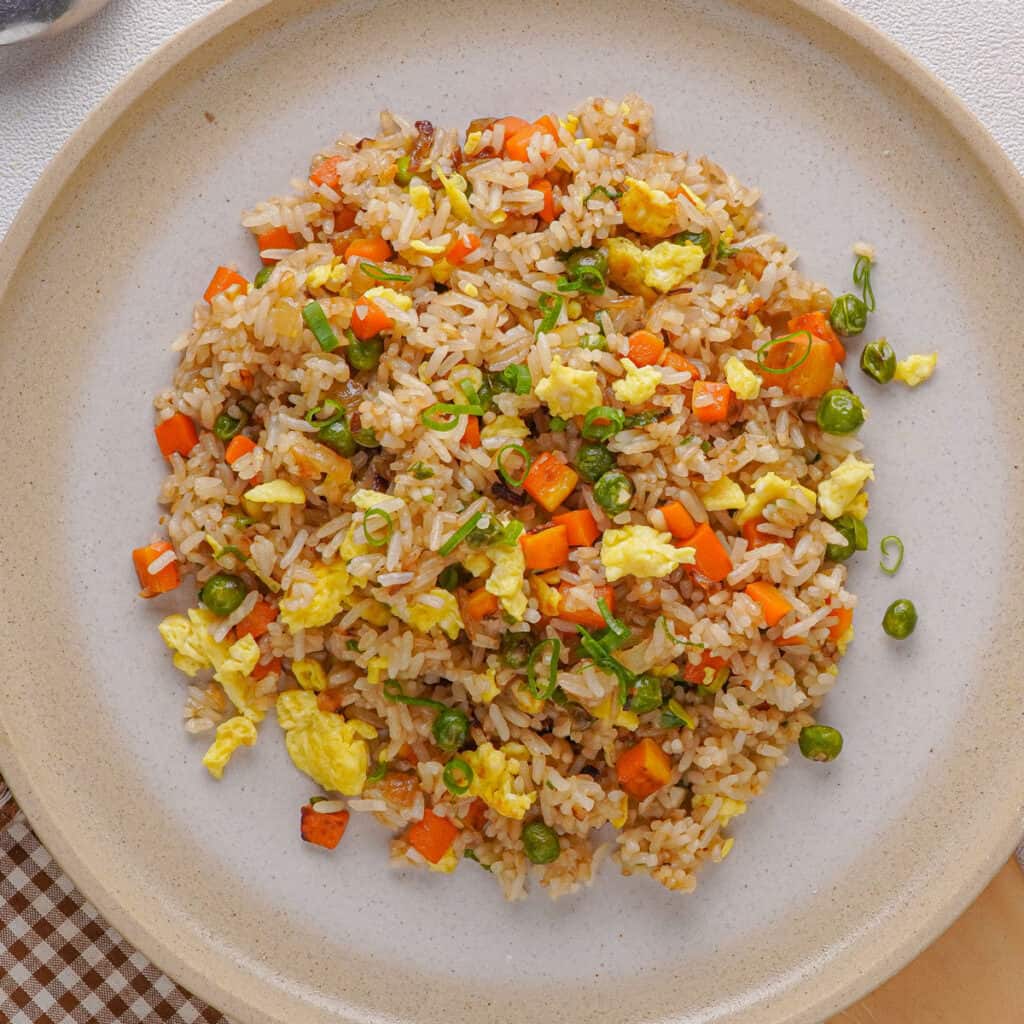 egg fried rice on a tan plate