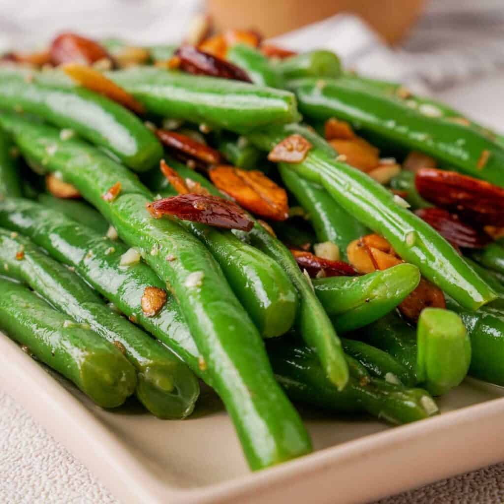 close up of green beans with almonds