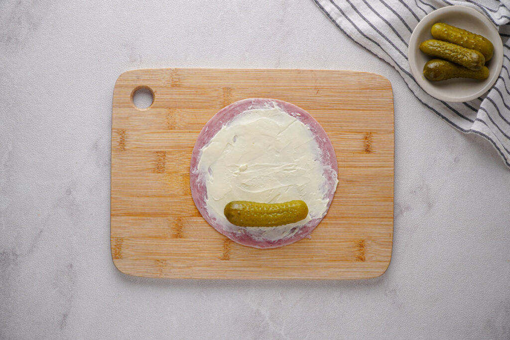 pickle on slice of ham with cream cheese