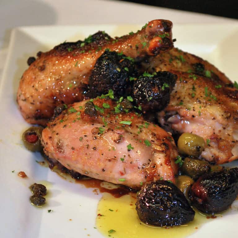 chicken marbella on white plate