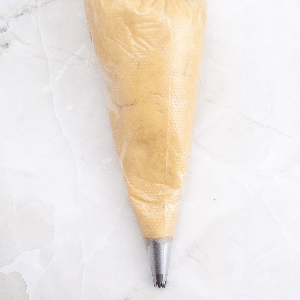 churro dough in piping bag