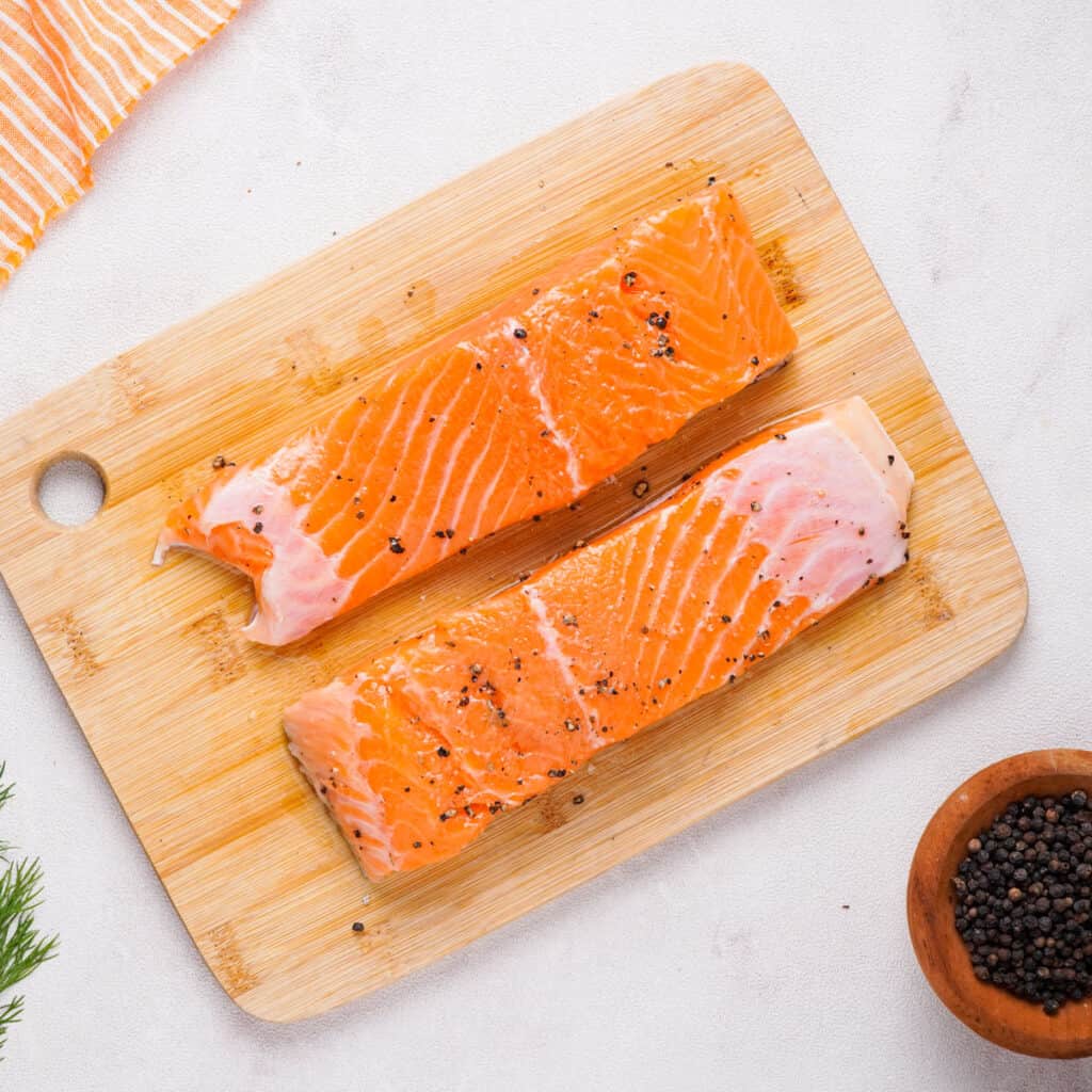 raw salmon on cutting board