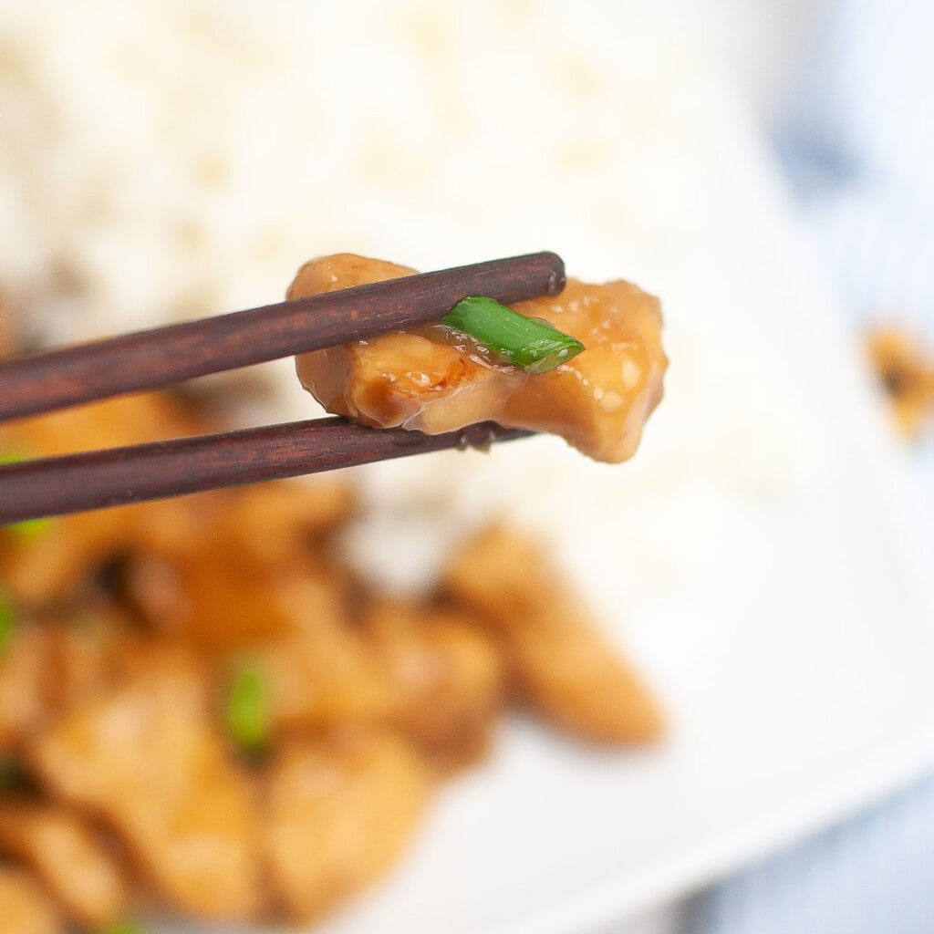 chopsticks holding piece of Slow Cooker Teriyaki Chicken