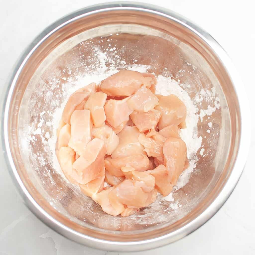 cubed chicken breast in metal bowl