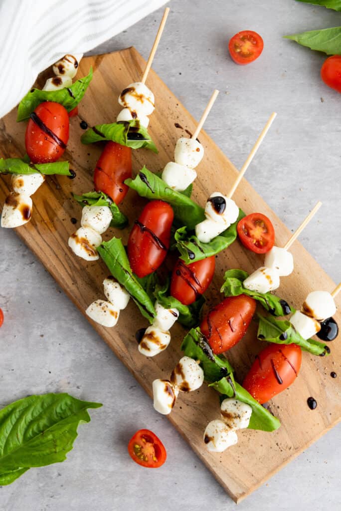 caprese skewers on cutting board