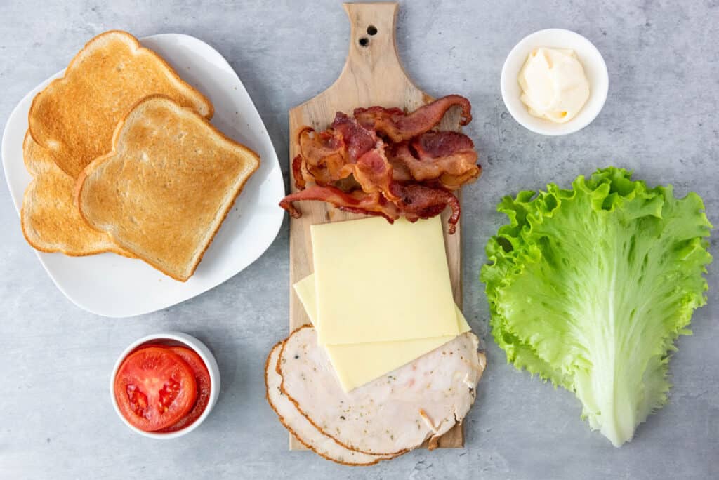 chicken club sandwich ingredients on counter