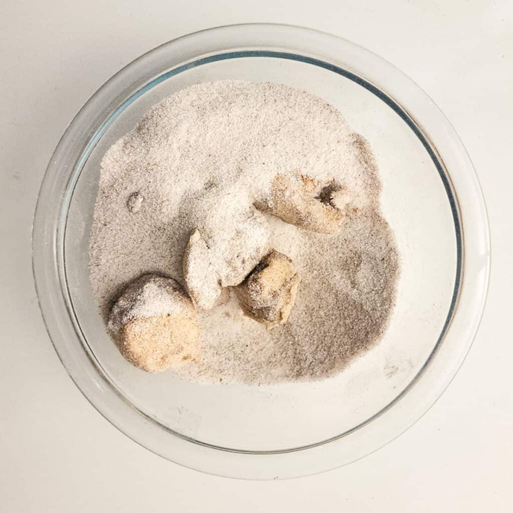 dough pieces in cinnamon sugar
