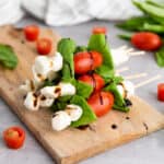 stack of caprese skewers on cutting board