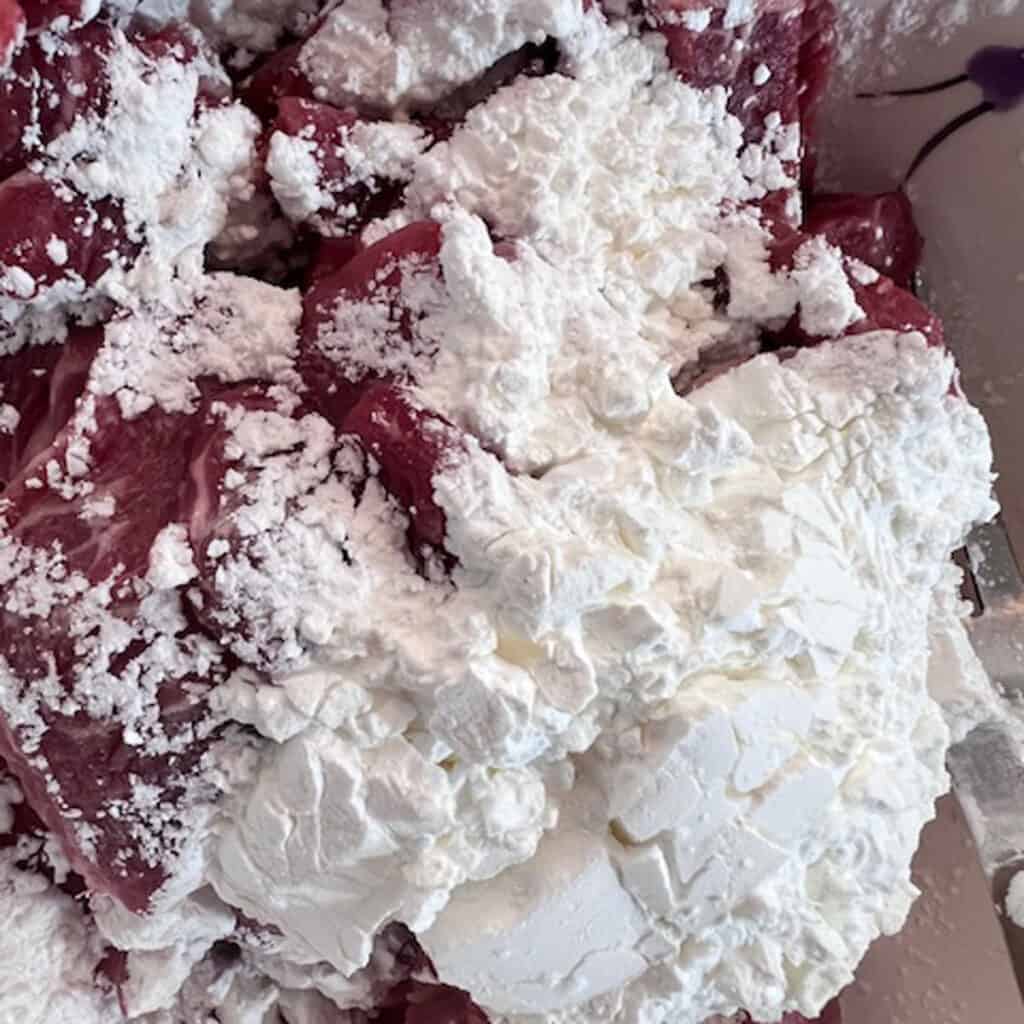 sliced flank steak with corn starch on top