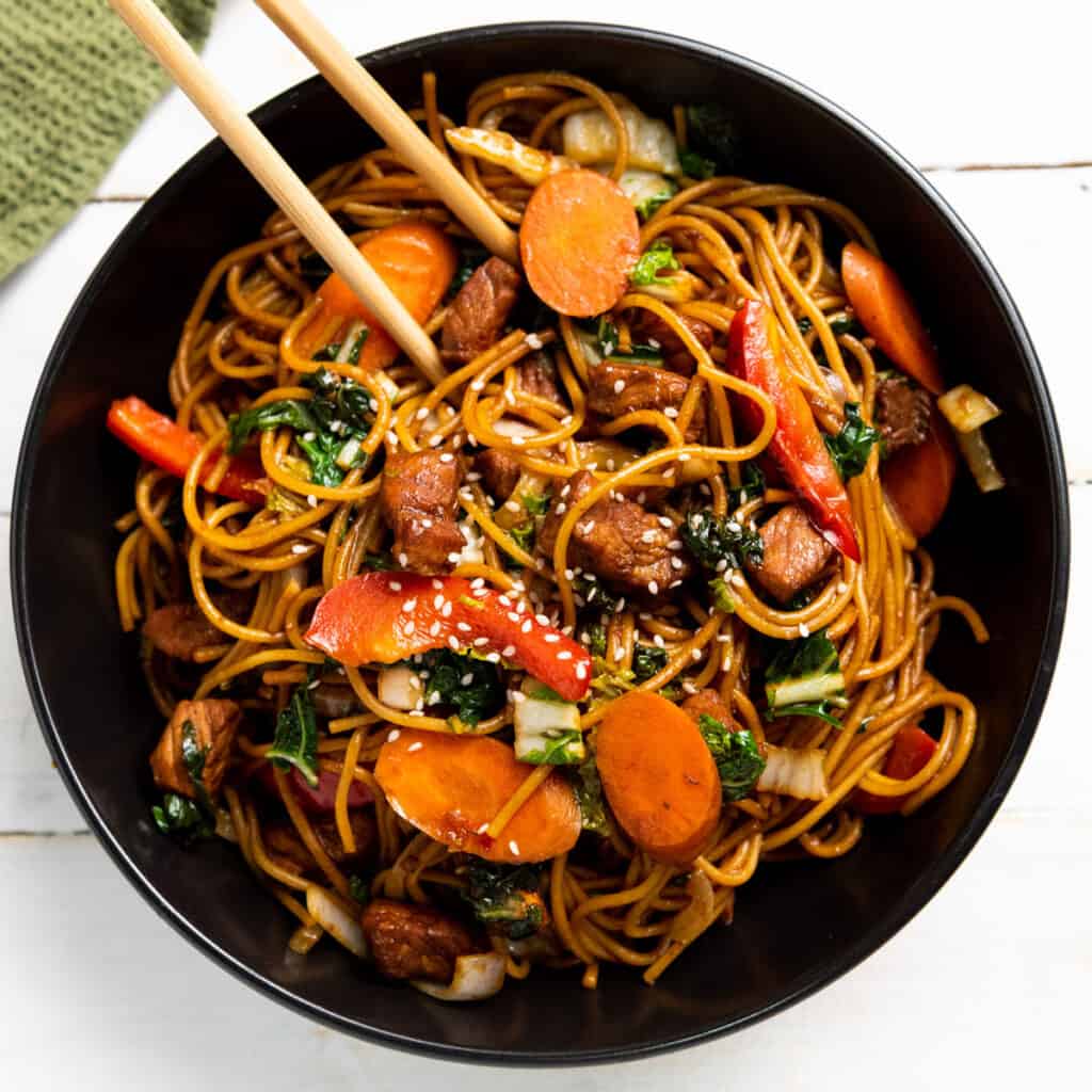 instant pot lo mein in black bowl with chopsticks